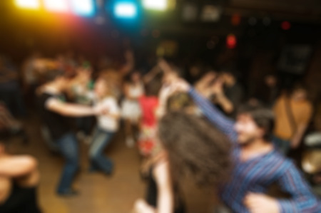 People dancing at the party abstract blur background with bokehの写真素材
