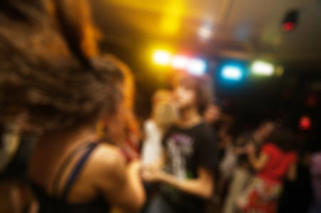 People dancing at the party abstract blur background with bokehの写真素材