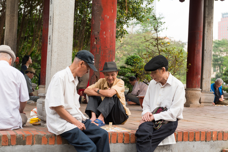 HANOI, VIETNAM - April 16, 2014 - Older people playing street chess near Hoan Kiem Lakeのeditorial素材