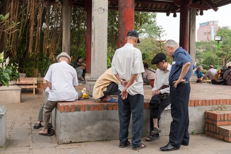 HANOI, VIETNAM - April 16, 2014 - Older people playing street chess near Hoan Kiem Lakeのeditorial素材