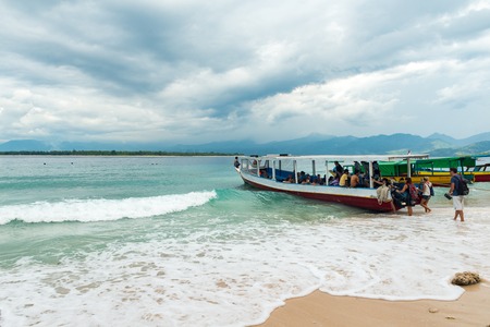 GILI MENO, INDONESIA - May 6, 2013 - Tourists boarding boat island hoppingのeditorial素材