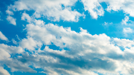 Blue sky with puffy white cloudsの写真素材