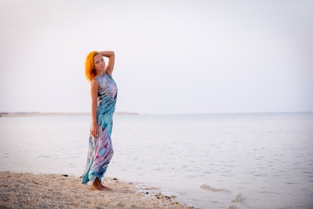 Young red woman on a beachの写真素材