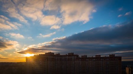Sun rising over cityの写真素材