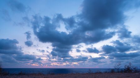 View of setting sun over Black Sea - clouds above horizontの写真素材