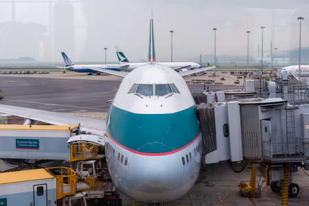 HONG KONG, CHINA - April 17, 2013: Cathay Pacific Airplane docked getting ready to flight at Hong Kong International airportのeditorial素材