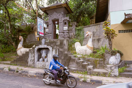 UBUD, BALI INDONESIA - April 18, 2013: Street scene in Ubud near busy roadのeditorial素材
