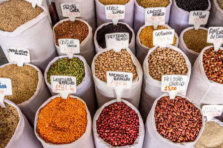 Bags of grains and cereals for sale in a farmer's market.