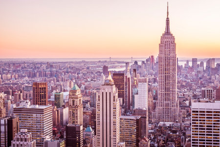 New York City Manhattan downtown skyline with Empire State Building at sunset.の写真素材
