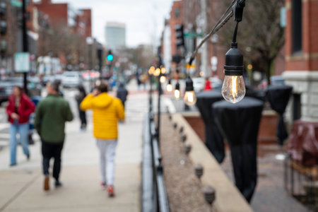 Blurred image of people walking in the streets of Boston, Massachusetts. Focus on the light bulb. Newbury street in Boston, Massachusetts, USA.の写真素材
