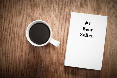 Taking a break with a cup of coffee and a number one best seller.