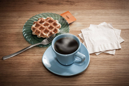 Space for your coffee shop or restaurant logo or message on napkins next to coffee and a snack.の写真素材