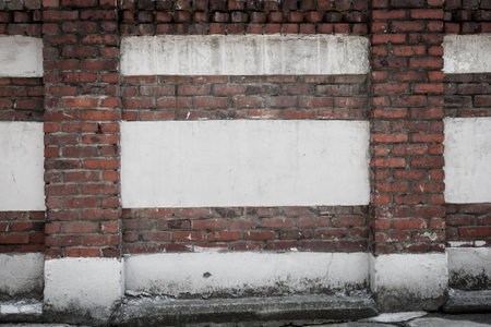 A somewhat weathered brick and stucco wall.の写真素材