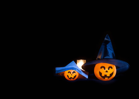 A pair of lighted jackolanterns are dressed up for Halloween.の写真素材