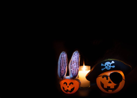A pair of lighted jackolanterns are dressed up for Halloween.の写真素材