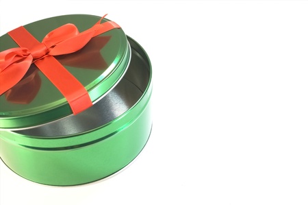 Green container with red bow isolated on white