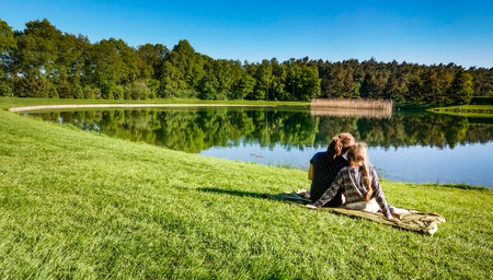 Young girls fishing at a lakeの写真素材