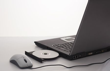 Laptop with mouse and cd-r diskの写真素材