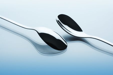 Two shiny spoons on the tableの写真素材