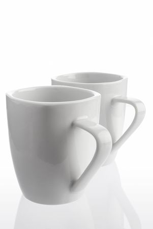 Pair of white coffee cups on white backgroundの写真素材
