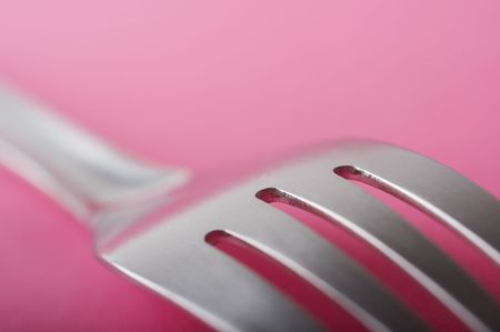 Close up of fork on the pink tableの写真素材