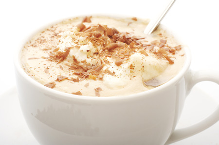 Macro close up of a coffee cup with cream top