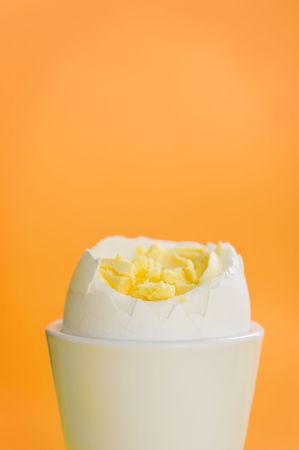 Boiled egg standing on the orange backgroundの写真素材