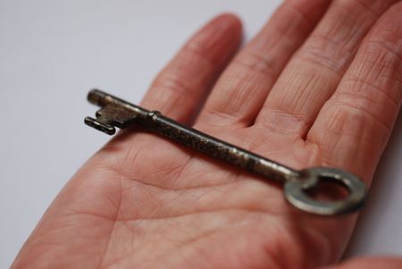 Old fashioned key on handの写真素材