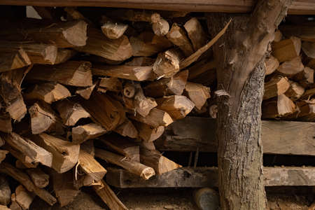 A pile of stacked chopped firewood logs close up. Dry chopped firewood in a pile close-up, side view.の写真素材