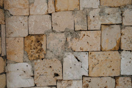 Old historical stone brick wall from a building close-up viewの写真素材