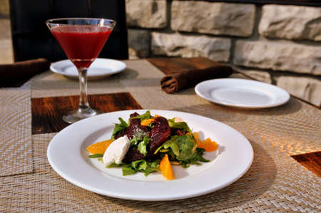Beet salad with arugula, orange, roasted beets and goat cheese mousse with Beet Vodka Martini の写真素材