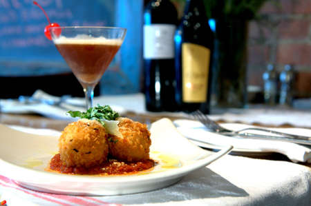 Stuffed Risotto Balls - Risotto balls, fried golden brown with a spicy tomato sauce and cocktail の写真素材