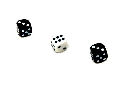 Three black and white bone dices, on a white backgroundの写真素材