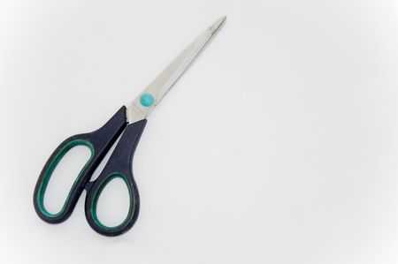 Closed steel scissor on a white backgroundの写真素材