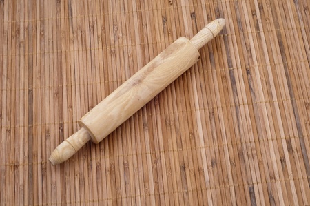Wooden roller  using by kitchen tool  on  bamboo backgroundの写真素材