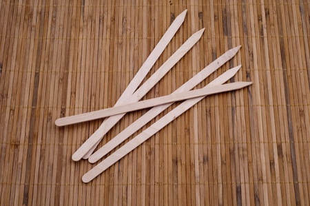 Wooden kebab sticks on bamboo backgroundの写真素材