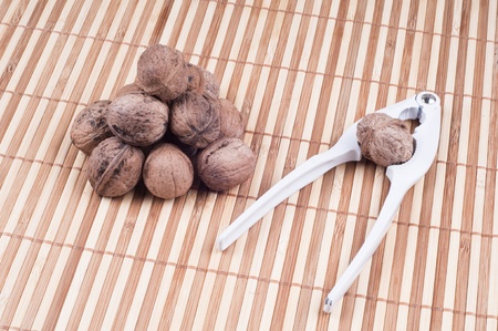 Walnuts and Cracker on bamboo backgroundの写真素材