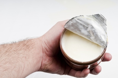 Open cream box holding on the human handの写真素材