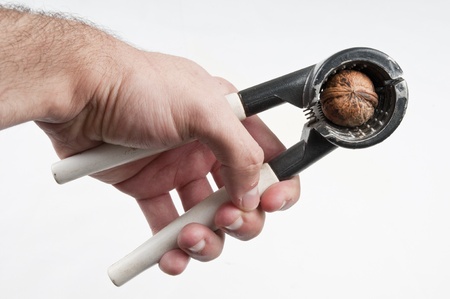 Human hand Nut Cracker pressing in the nutの写真素材
