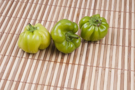 three pepper on bamboo backgroundの写真素材