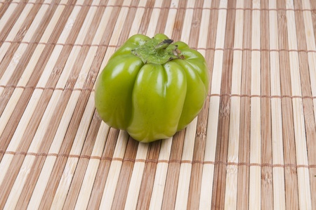 a pepper on bamboo backgroundの写真素材