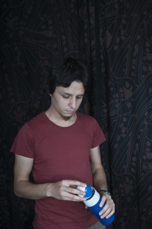 Young turkish guy holding juggling balls on black backgroundの写真素材