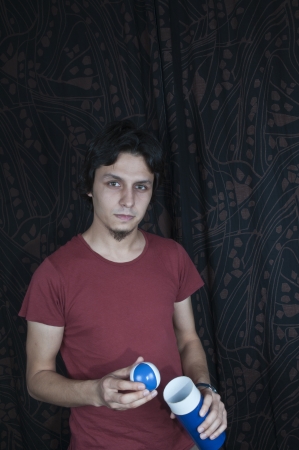 Young turkish guy holding juggling balls on black backgroundの写真素材
