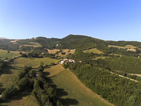 aerial shot of a little village surrounded by nature of Monti Sibillini National Park , Collevecchio, Macerata, Italyの写真素材
