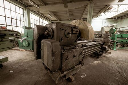 Old lathe machinery in ironworks factoryの写真素材