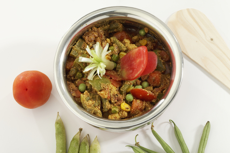 Indian vegetarian dish Mix vegetable in steel pot with raw vegetables.の写真素材