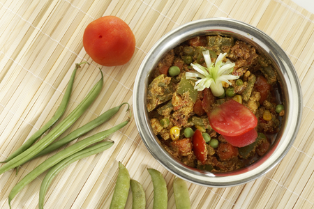 Indian vegetarian dish Mix vegetable in steel pot with raw vegetables.の写真素材