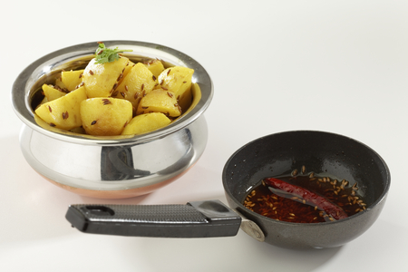 Indian dish fried potato with cumin along with cumin and chilly in oil.の写真素材
