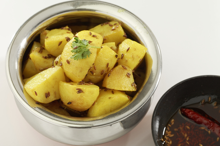 Indian dish fried potato with cumin along with cumin and chilly in oil.の写真素材