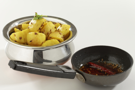 Indian dish fried potato with cumin along with cumin and chilly in oil.の写真素材